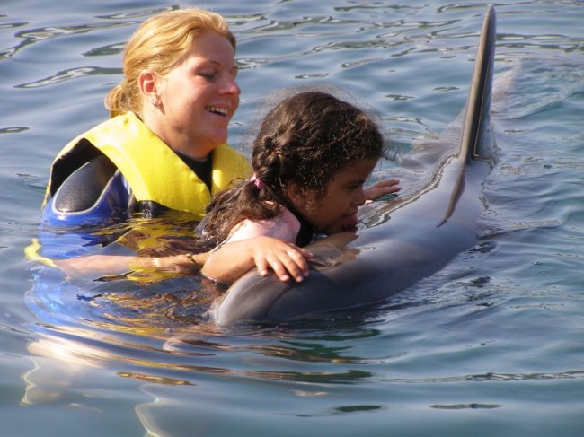 Dilsah was swimming with a Dolphin